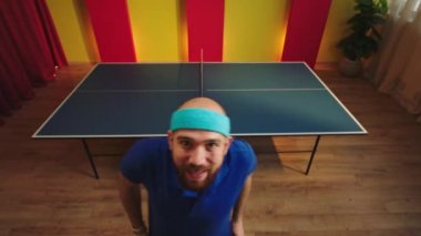 Closeup to the camera ping pong player came to the camera looking straight then walking to the table tennis and start the game with his colleague. 4k
