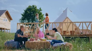 At the campground the group of friends have a picnic they discussing and enjoy the time together at the nature. Shot on ARRI