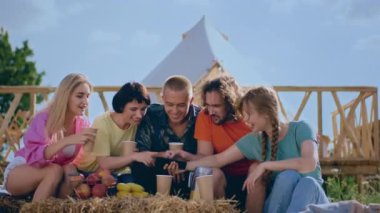 Perfect summer day group of multiracial friends meeting all together to speeding a good time together at the campsite they drinking something and smiling large. 4k