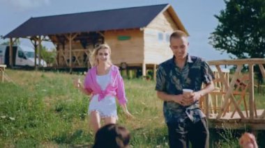 Multiethnic group of friends meeting at the campsite ladies and men they enjoy the time at nature they taking pictures and feeling in love. 4k