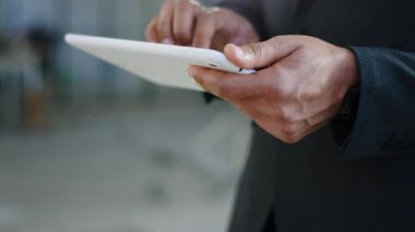 Taking video details of a businessman holding digital tablet and make some notes at construction site.
