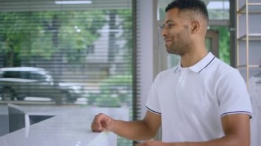 Good looking man came to the medical clinic at reception desk and take his medical card from the medical assistant. 4k