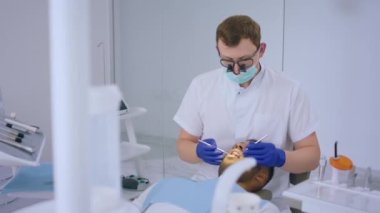 Modern dental clinic the dentist using dental instruments for tooth treatment on patient the patient laying down on the dentist chair concept of healthcare. 4k