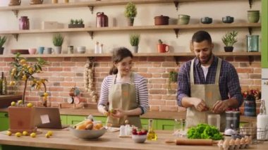 Perfect morning for a multiracial couple at the kitchen they discussing together while preparing the healthy breakfast together. 4k