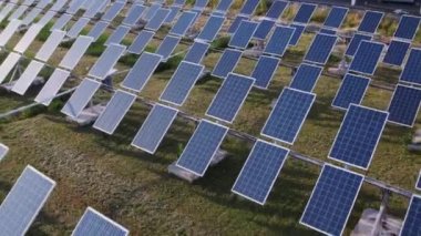 At solar power station engineers checking the solar panels taking video with drone birds eye view concept of green energy. 4k