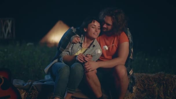 迷人的女人和英俊的男人在营地的夜晚 坐在干草堆里 一起煮一些棉花糖 对Arri开枪 — 图库视频影像