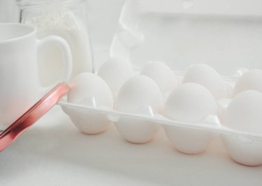 white eggs in a tray on a table