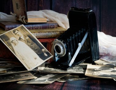 old vintage photo camera with photos 