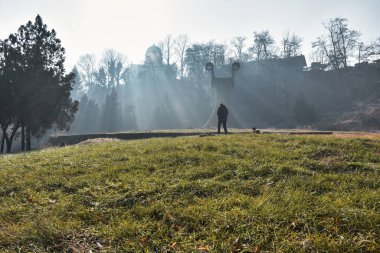 man walking dog in the park at the morning 