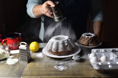 close up of a chef decorates homemade cake with sugar powder
