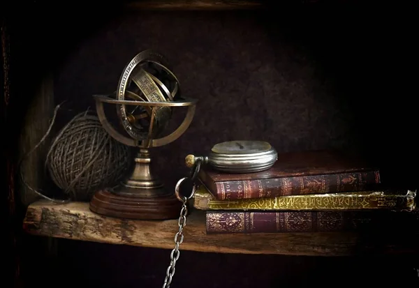 old books and vintage clock on black background 