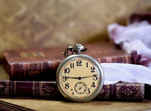 old vintage pocket clock and books 