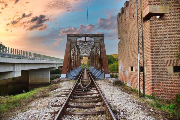 Old metal train bridge across the river