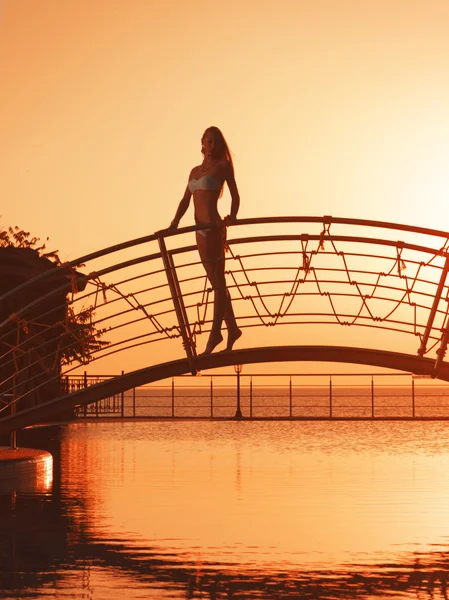 Girl on the bridge over pool — Stock Photo, Image