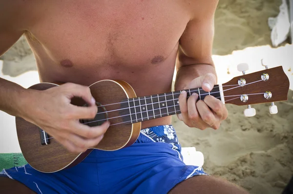 Boy playing the ukulele — Stock Photo, Image