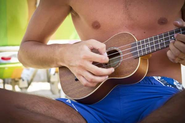 Boy playing the ukulele — Stock Photo, Image