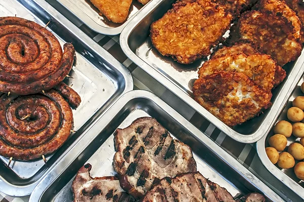 Sausage, ham, schnitzel and potatoes — Stock Photo, Image