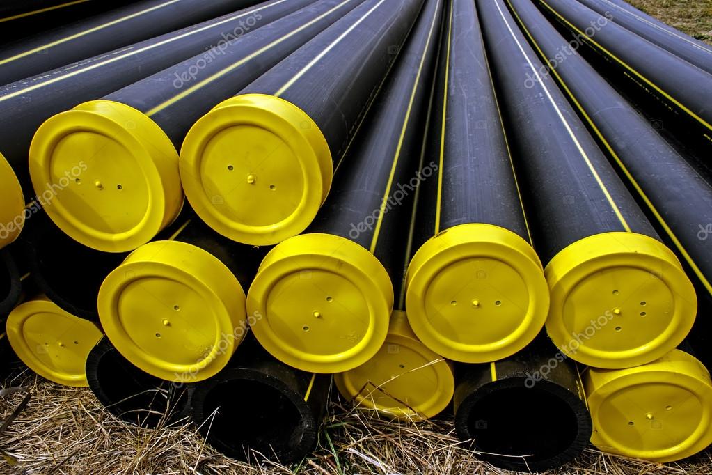 Black plastic pipes with yellow caps — Stock Photo © florin1961 13381977