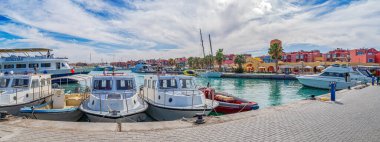 HURGHADA, EGYPT - APRIL 22, 2022: Hurghada Marina, commercial and touristic port with colored boats and yachts and American Maritime Academy.