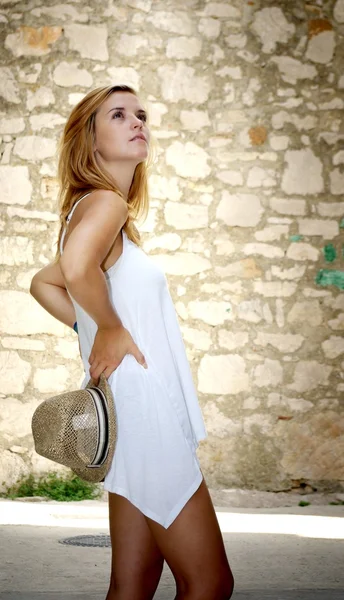 Beautiful woman visits the old stone town — Stock Photo, Image