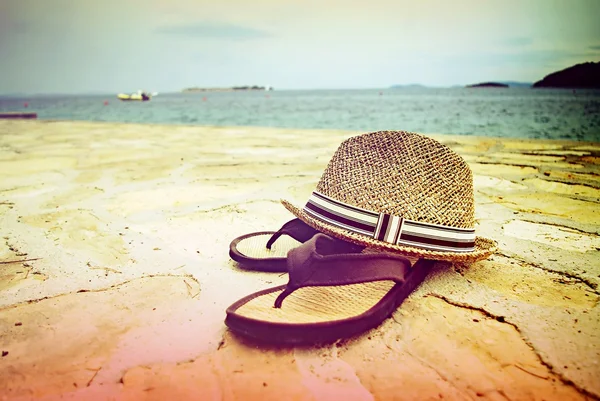 Strand sandalen en stro hoed door de zee, Kroatië Dalmatië — Stockfoto