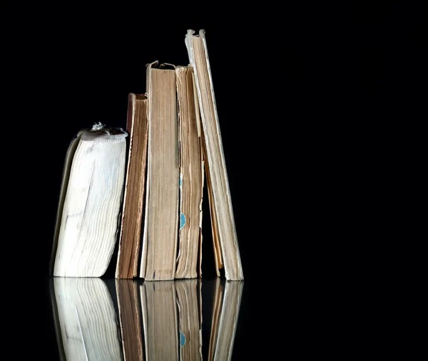 Pile of old books with vintage pages reflected — Stock Photo, Image