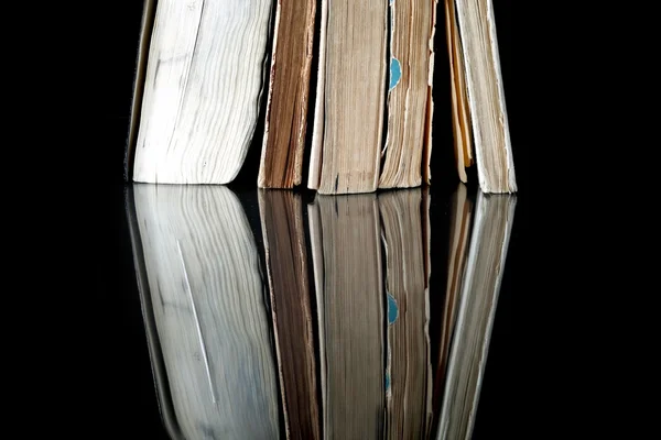 Pile of old books with vintage pages reflected — Stock Photo, Image