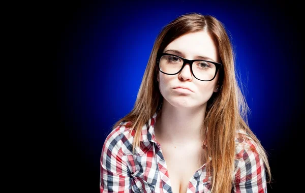 Disappointed and sad young girl with large nerd glasses — Stock Photo, Image