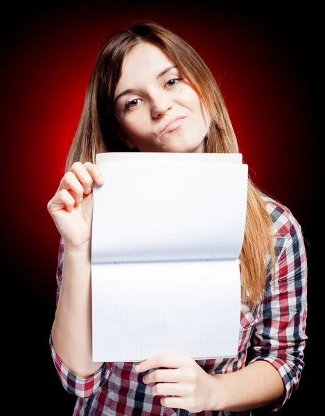 Disappointed young girl holding exercise book — Stock Photo, Image