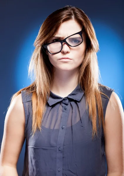 Disappointed young woman with nerd glasses has objections — Stock Photo, Image