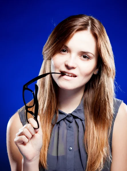 Mujer joven mordiendo un nerd gafas con mirada interesada —  Fotos de Stock