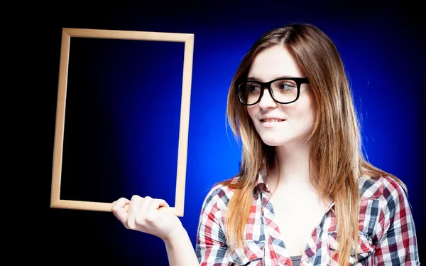 Mujer sonriente con gafas nerd sosteniendo marco — Foto de Stock