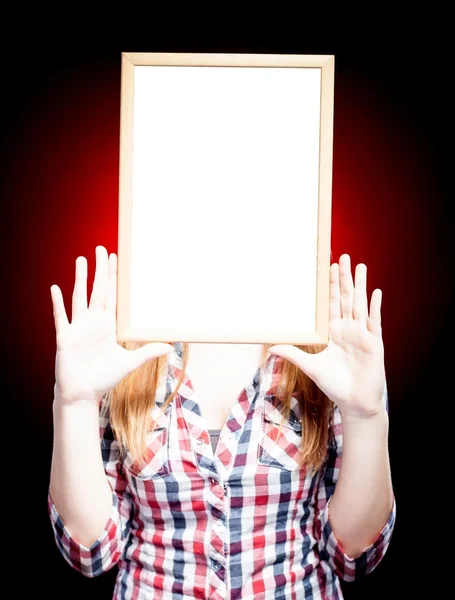 Young woman wearing plaid shirt holding empty frame — Stock Photo, Image