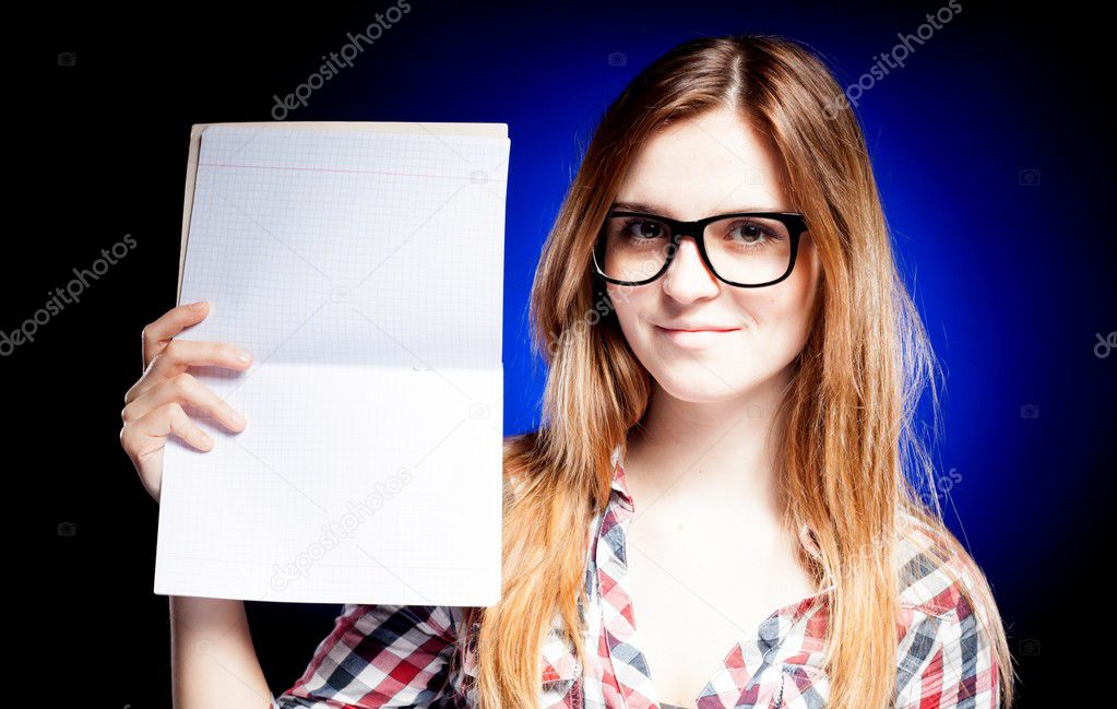 Happy young girl with nerd glasses holding exercise book