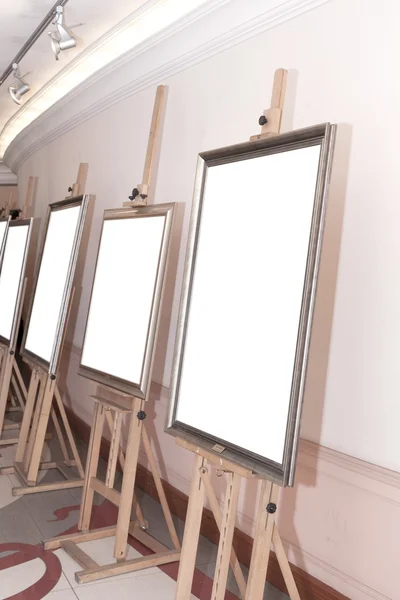Corridor with blank frames on painting easel — Stock Photo, Image