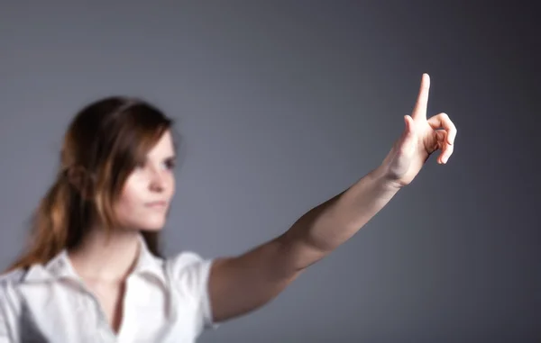 Woman with raised hand and one finger dark background — Stock Photo, Image