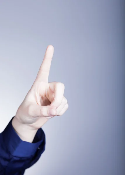 Mano de mujer con dedo, fondo azul — Foto de Stock