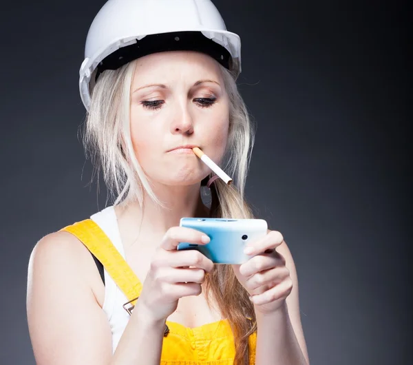 Young architect woman construction worker, cigarette and phone — Stock Photo, Image