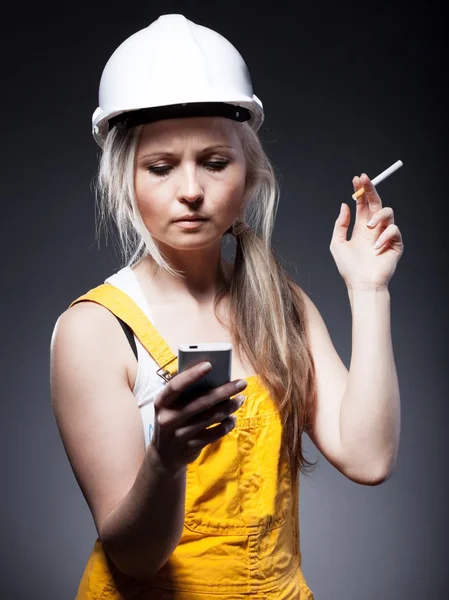 Young architect woman construction worker, cigarette and phone — Stock Photo, Image