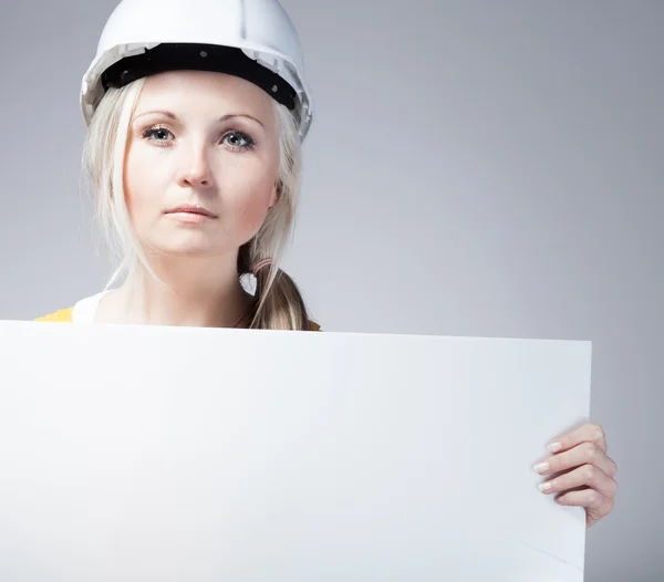 Young builder craftswoman construction worker, empty banner — 스톡 사진