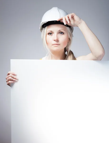 Young builder woman construction worker, empty poster — 스톡 사진