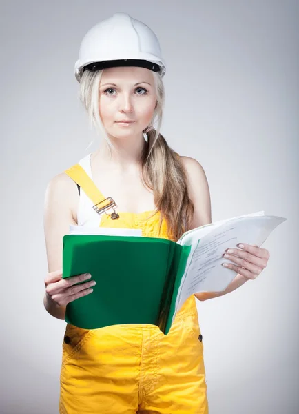 Young builder woman construction worker, blueprints plan — Stock Photo, Image