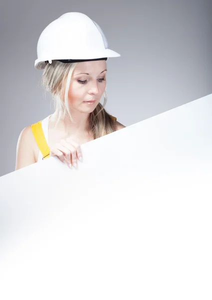 Young builder woman construction worker, empty poster — 스톡 사진