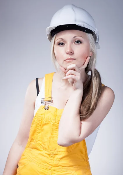 Young builder woman construction worker, thinking — Stock Photo, Image