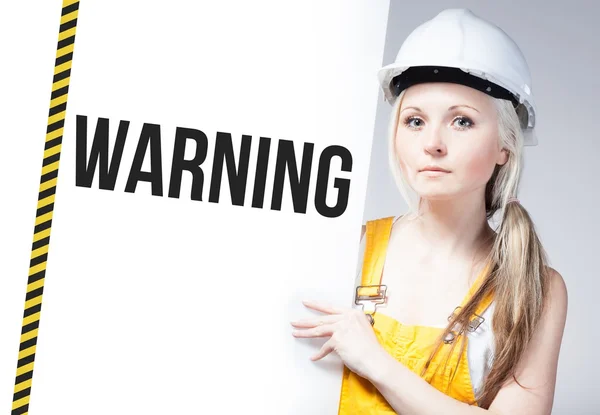 Worker holding warning sign on information board — Stock Photo, Image