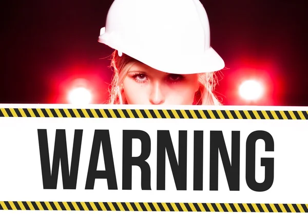 Worker holding warning sign on information board — Stock Photo, Image