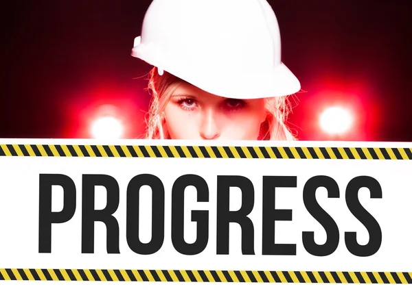 Worker holding progress sign on information board — Stock Photo, Image