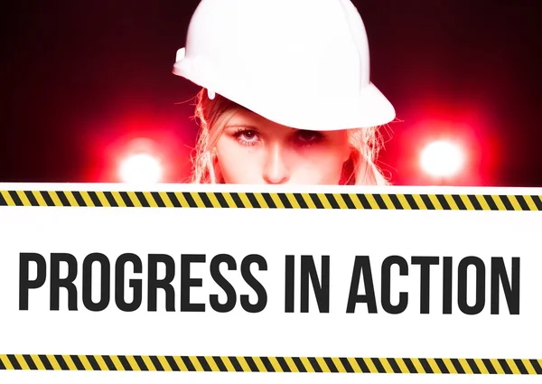 Worker holding progress in action sign on information board — Stock Photo, Image