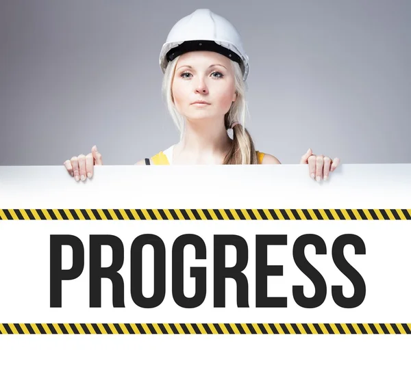 Worker holding progress sign on information board — Stock Photo, Image