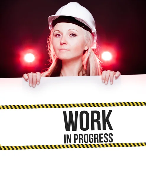 Caution sign held by worker — Stock Photo, Image